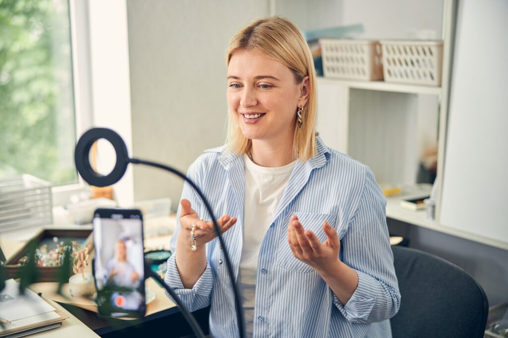 Image credit : dribbble.com/illiyinstudio Pleased woman making a video about jewelry production